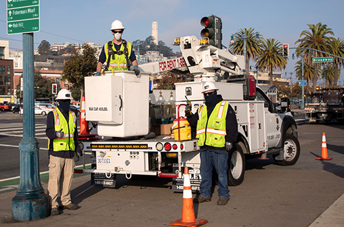 SFPUC power workers with vests and hard hats.