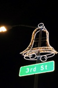 large bell shaped light on top of street sign