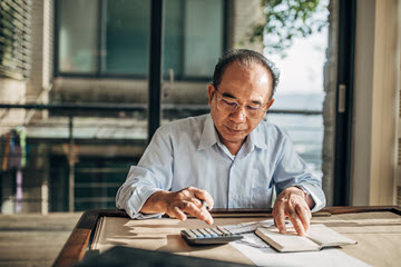 Older man using a calculator